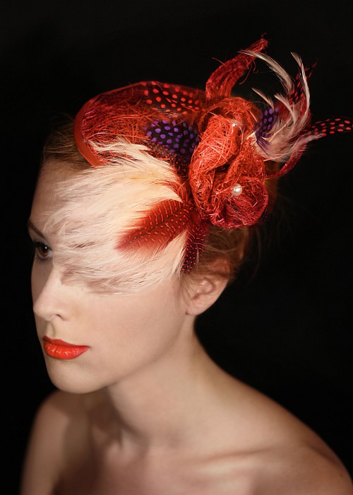 Red fascinator hat with flower and feathers 