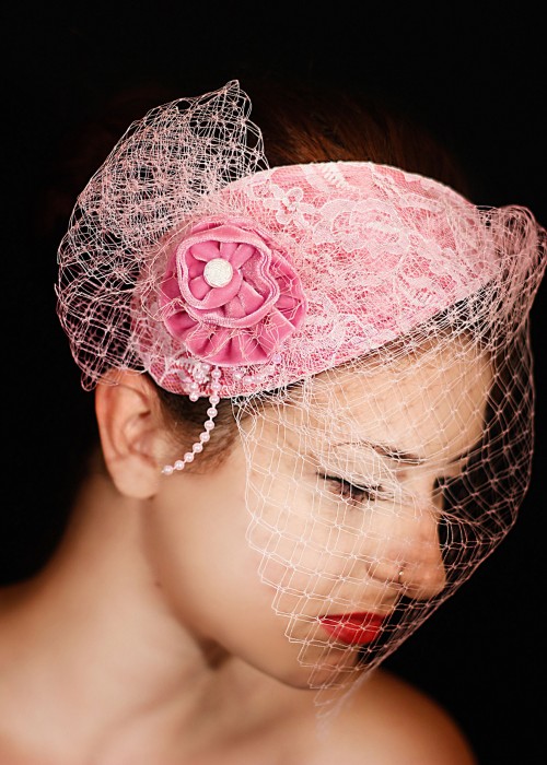 Pink satin fascinator hat with teardrop shape with veil 