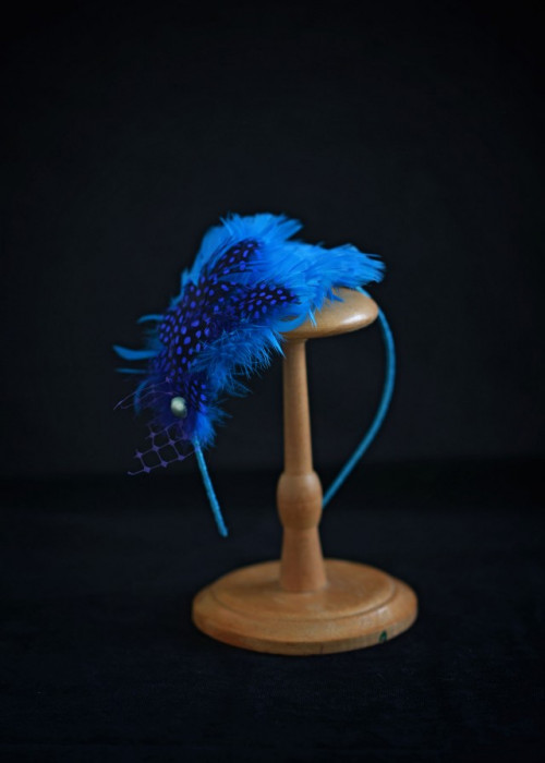 Blue headpiece with feathers mounted on headband